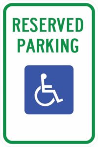 A sign that shows the  International Symbol of Access and reads, "Reserved Parking"